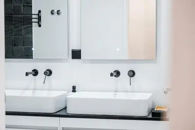 two white sinks in a bathroom with two mirrors at GuestReady - Relax and Recharge in Funchal in Funchal