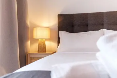 a bedroom with a bed and a lamp on a night stand at GuestReady - Relax and Recharge in Funchal in Funchal