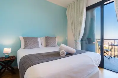 a bedroom with a large bed and a balcony at GuestReady - Private Terrace Stay in Funchal