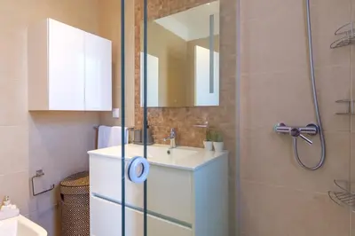 a bathroom with a sink and a shower with a mirror at GuestReady - Private Terrace Stay in Funchal