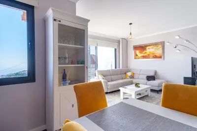 a living room with a table and a couch at GuestReady - Private Terrace Stay in Funchal