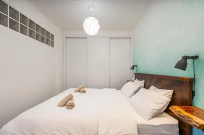 a bedroom with a white bed with towels on it at Studio Sardinha-1 min walk to beach in Burgau