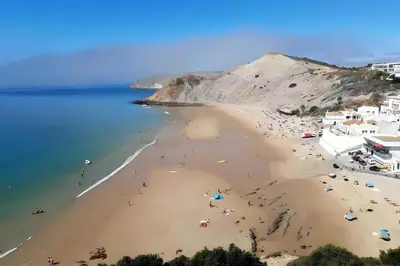 an aerial view of a beach with people on it at Studio Sardinha-1 min walk to beach in Burgau