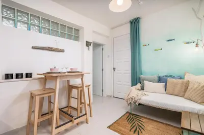 a living room with a couch and a table at Studio Sardinha-1 min walk to beach in Burgau