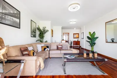 a living room with a couch and a table at SUPER Atalaia in Caniço