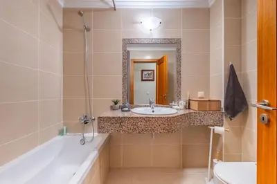 a bathroom with a sink and a tub and a mirror at SUPER Atalaia in Caniço