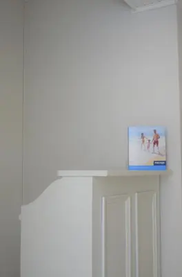 a box on top of a white shelf in a room at Apartamentos Turísticos Vitoria by Petit Hotels in Funchal