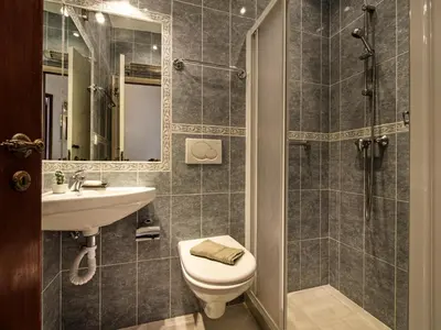 a bathroom with a toilet and a sink and a shower at Villa Bort Oss in Luz