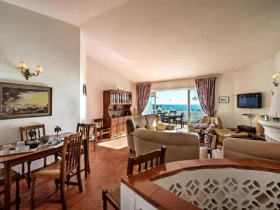 a living room with a couch and a table and chairs at Villa Bort Oss in Luz