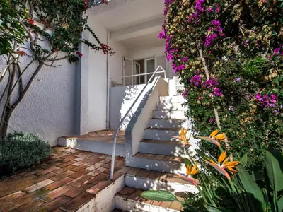 a staircase leading to a house with flowers at Villa Bort Oss in Luz