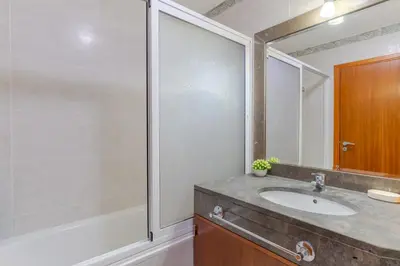 a bathroom with a sink and a large mirror at Ivanna Apartament by Holiday Rental Madeira in Funchal