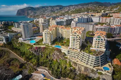 an aerial view of a city with buildings and the ocean at Ivanna Apartament by Holiday Rental Madeira in Funchal