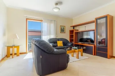 a living room with a leather couch and a television at Ivanna Apartament by Holiday Rental Madeira in Funchal