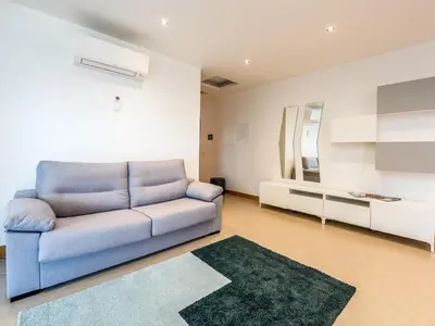 a living room with a blue couch and a mirror at Apt. A Nice Home in Lagos