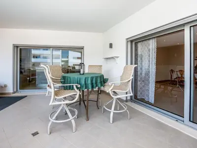 a patio with a table and chairs on a balcony at Apt. A Nice Home in Lagos