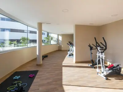 a gym with treadmills and exercise bikes in a building at Apt. A Nice Home in Lagos