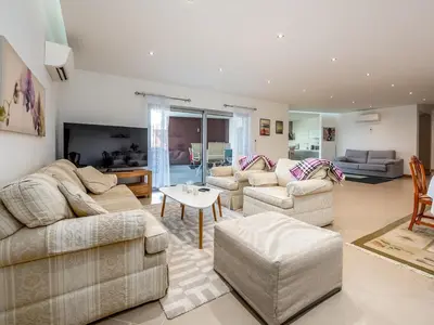 a living room with two couches and a table at Apt. A Nice Home in Lagos