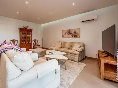 a living room with a couch and a tv at Apt. A Nice Home in Lagos