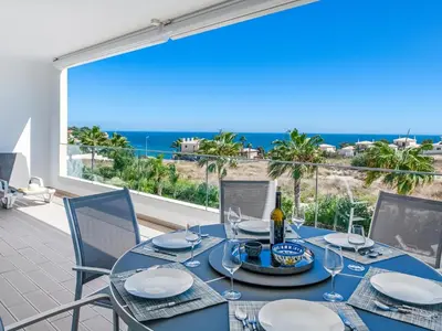 a dining table with a view of the ocean at Apt. Seabreeze in Lagos