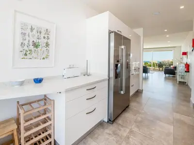 a kitchen with white cabinets and a refrigerator at Apt. Seabreeze in Lagos