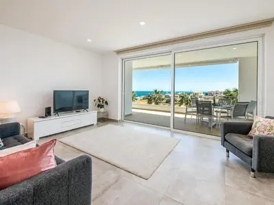 a living room with a tv and a large window at Apt. Seabreeze in Lagos