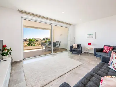 a living room with a couch and a table with chairs at Apt. Seabreeze in Lagos