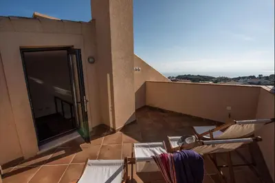 a balcony with a table and chairs on a building at Apt. Arribas in Luz