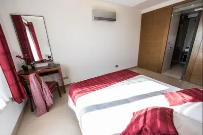 a bedroom with two beds and a table and a mirror at Apt. Arribas in Luz