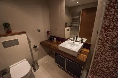 a bathroom with a white sink and a toilet at Apt. Arribas in Luz