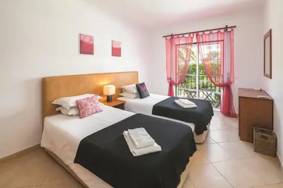 a hotel room with two beds and a window at Apt. Palmeira in Luz