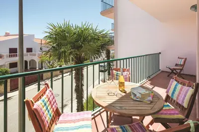 a balcony with a table and chairs on a balcony at Apt. Palmeira in Luz