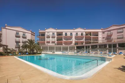 a large swimming pool in front of some buildings at Apt. Palmeira in Luz