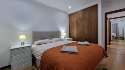 a bedroom with a bed with two towels on it at Lexus Apartment - Garajau in Caniço