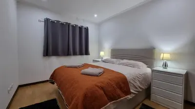 a bedroom with a bed with two towels on it at Lexus Apartment - Garajau in Caniço