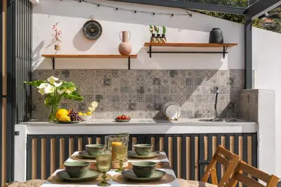 a table with plates and glasses on top of a kitchen at Villa Island Roots by An Island Apart in Calheta