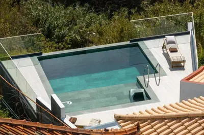 an overhead view of a swimming pool with two chairs at Villa Island Roots by An Island Apart in Calheta