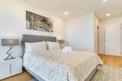 a white bedroom with a bed with a teddy bear on it at Luxury Laura Apartment by Holiday Rental Madeira in Funchal