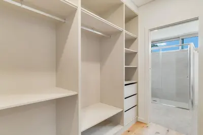 a walk in closet with white shelves and a window at Luxury Laura Apartment by Holiday Rental Madeira in Funchal