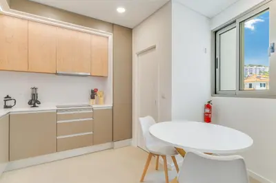a kitchen with a white table and white chairs at Luxury Laura Apartment by Holiday Rental Madeira in Funchal