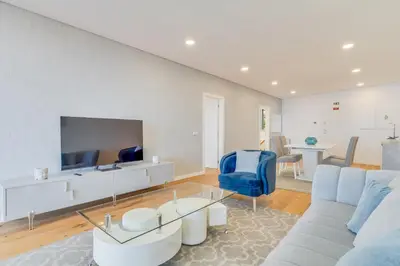 a living room with a blue couch and a tv at Luxury Laura Apartment by Holiday Rental Madeira in Funchal