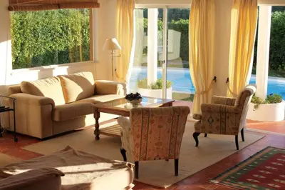 a living room with a couch and a table and chairs at Casa 3 in Raposeira
