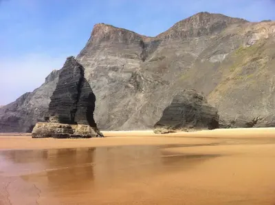 a view of a beach with cliffs and water at Casa 3 in Raposeira