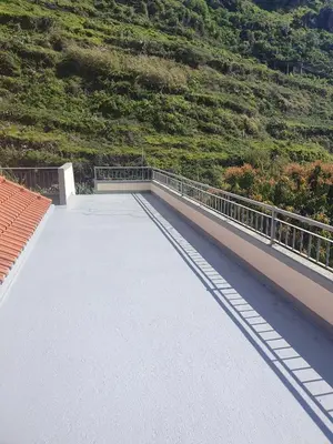 a bridge with a mountain in the background at Casa do Moinho - TABUA in Ribeira Brava