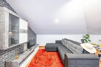 a living room with a couch and a tv at Casa da Achada by YOUR KEY in Santana