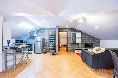 a kitchen and living room with a couch and a table at Casa da Achada by YOUR KEY in Santana