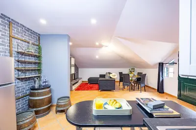 a kitchen and a living room with a table at Casa da Achada by YOUR KEY in Santana