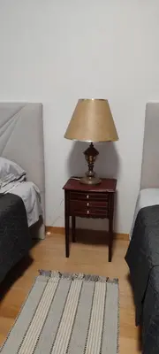 a lamp on a table in a room with two beds at Vista Praia Apartment in Funchal