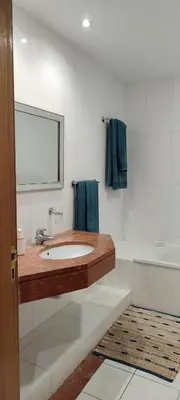 a bathroom with a sink and a mirror at Vista Praia Apartment in Funchal