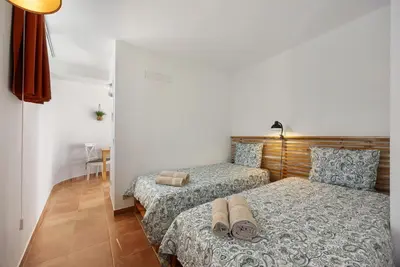 two beds in a room with towels on the bed at Apartment Amado - Carrapateira in Carrapateira