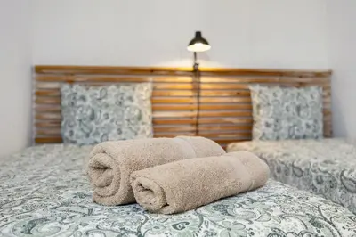 a pile of towels sitting on top of a bed at Apartment Amado - Carrapateira in Carrapateira